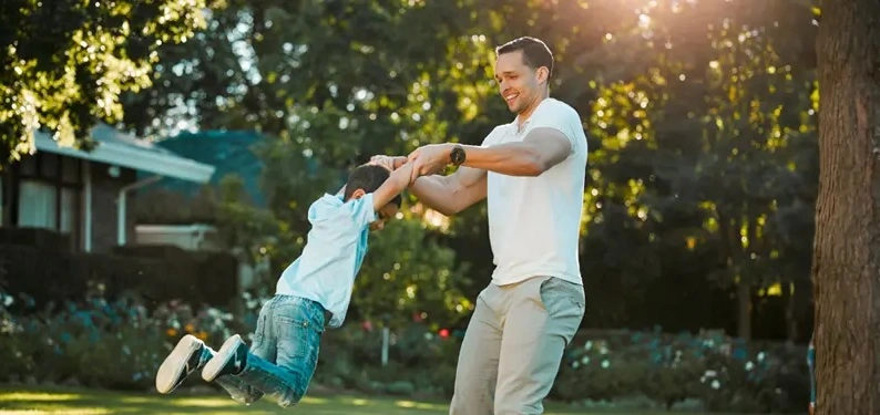 father-playing-with-kids-backyard