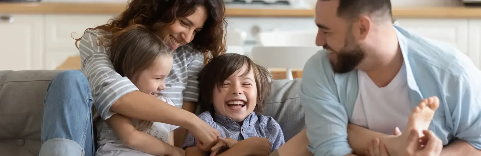 family laughing on couch in pest free home