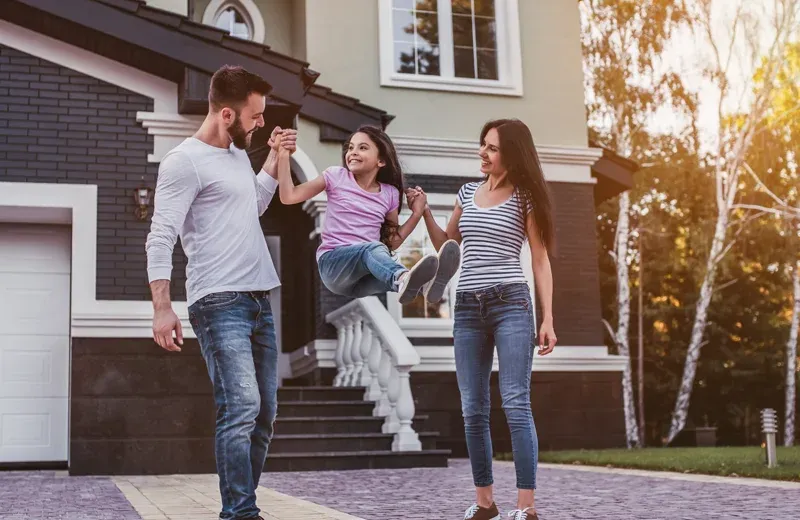 family playing outside home